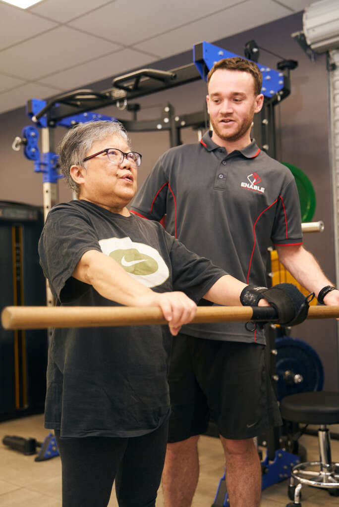 Exercise physiologist guiding stroke patient through rehabilitation exercises at Enable Exercise Canterbury