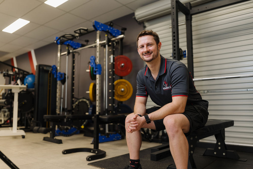 Exercise physiologist at Enable Exercise smiling in the gym