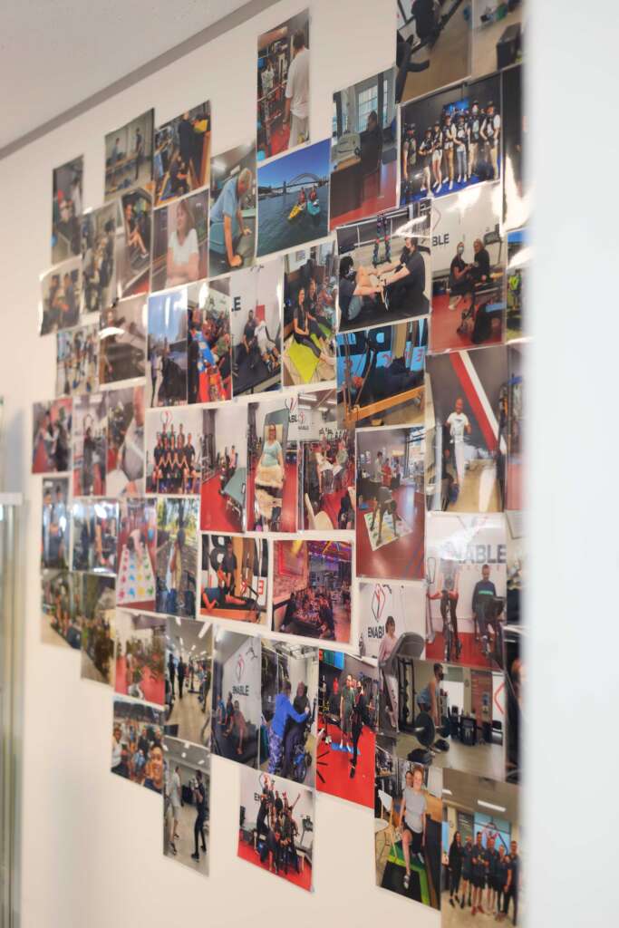 Wall of photos showcasing clients and staff at Enable Exercise clinic in Sydney
